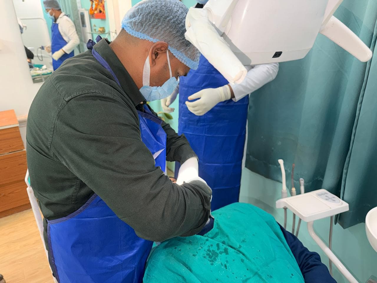 Dr. Indu Bhushan performing dental treatment